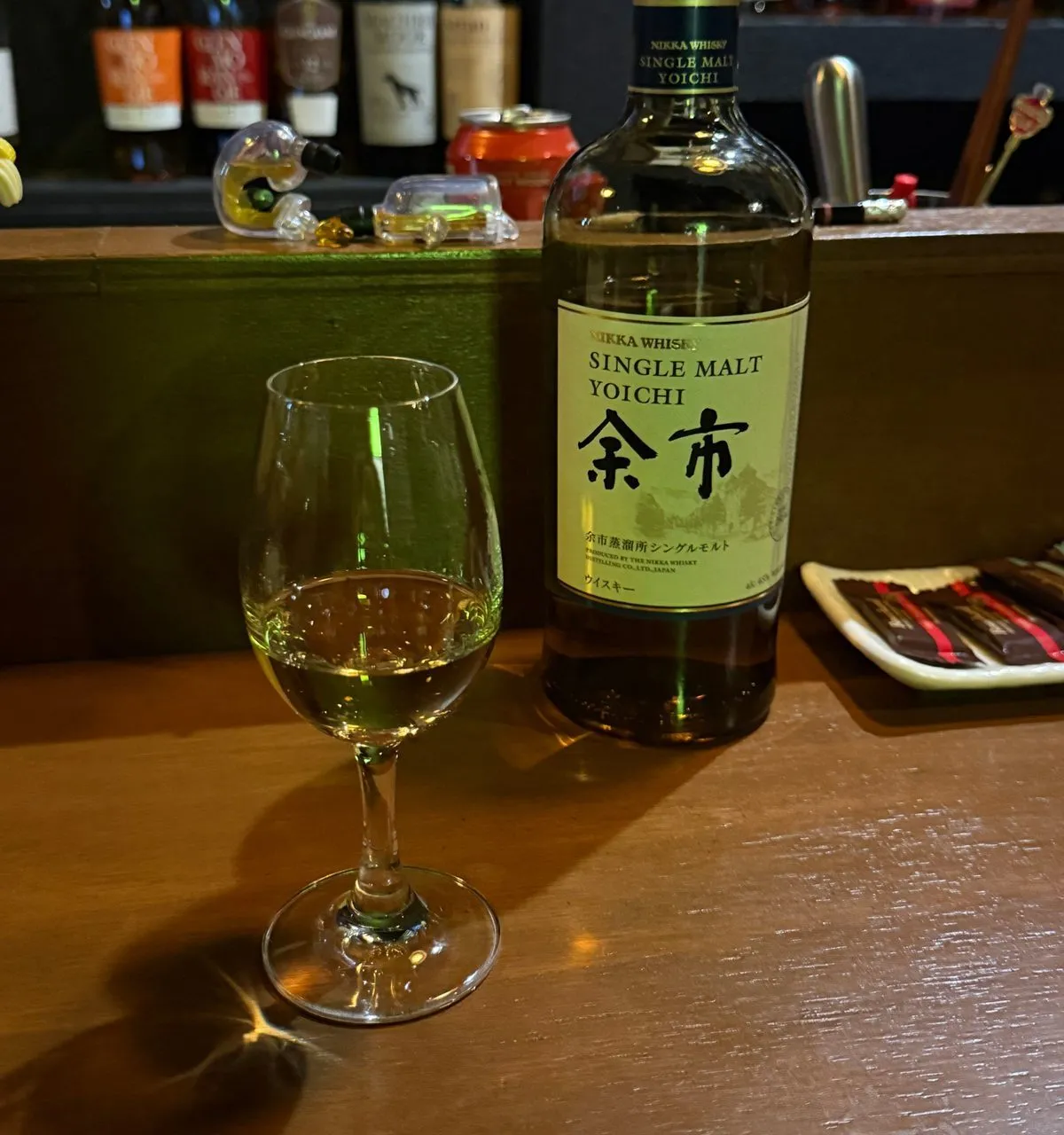 A bottle of Yoichi single malt next to a whisky glass