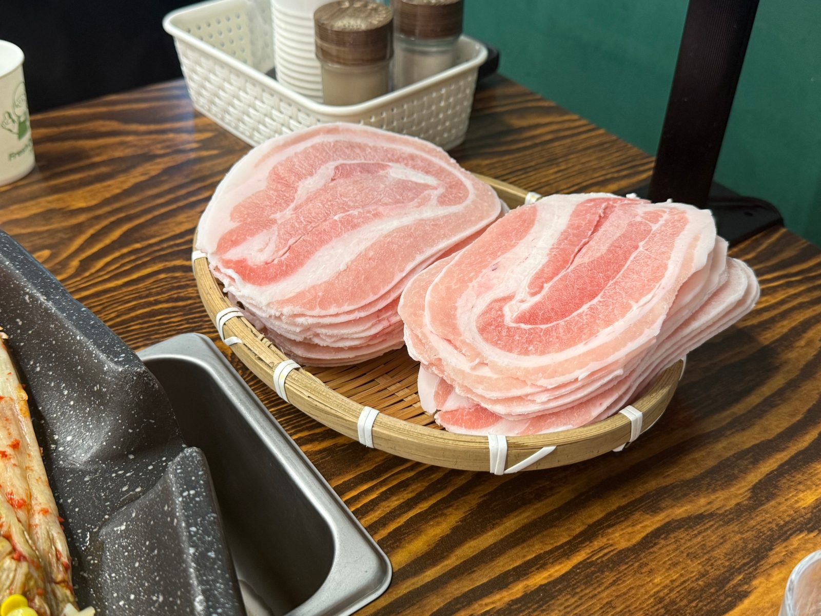 Thin frozen pork belly layered in a bamboo basket