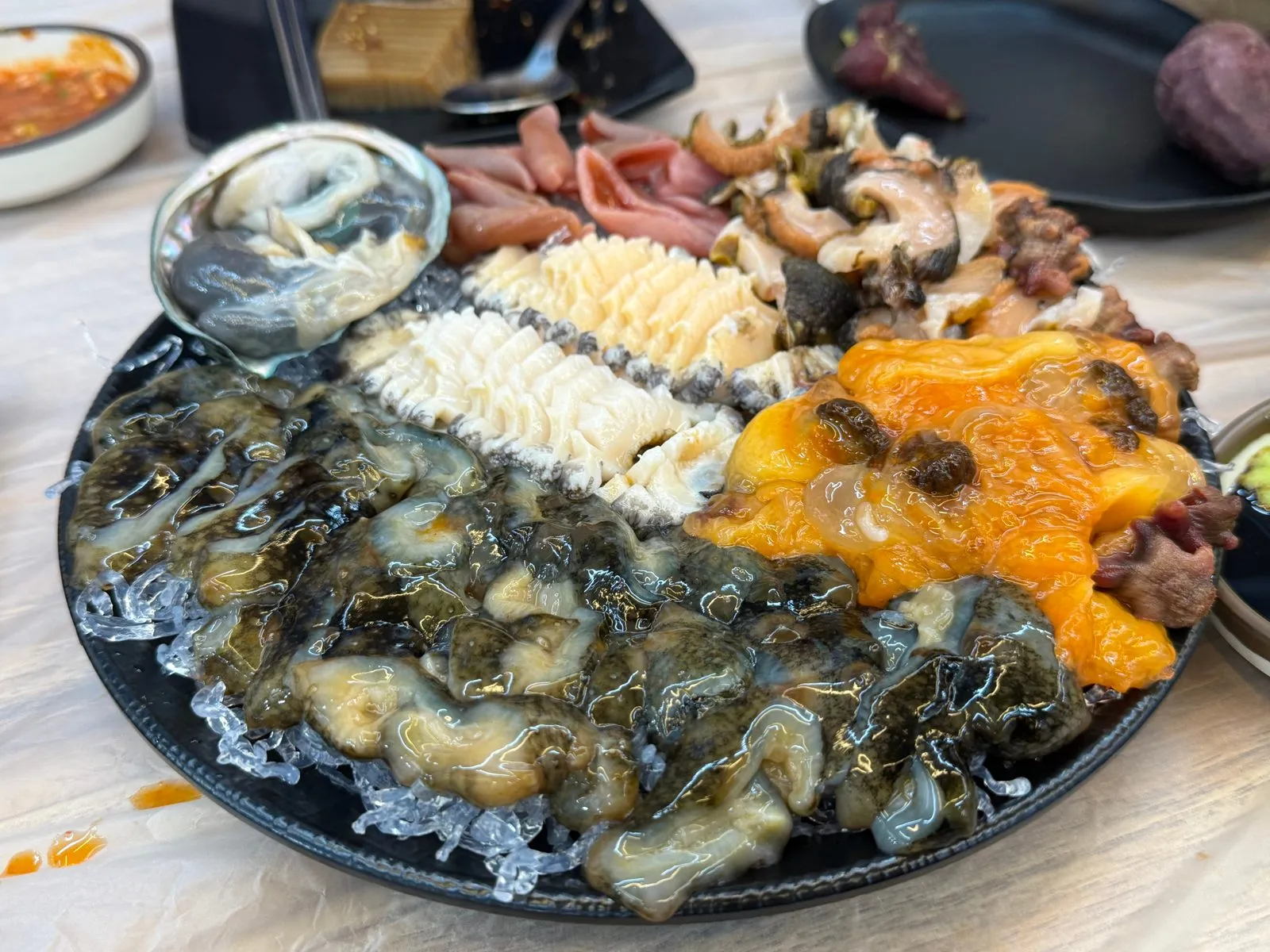 A round plate of assorted seafood arranged on ice