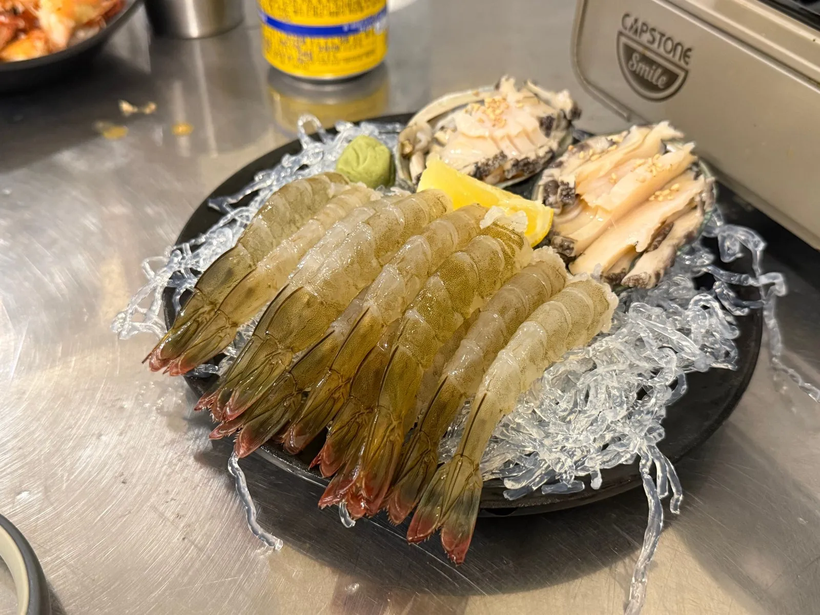 Raw shrimp and raw abalone served on ice