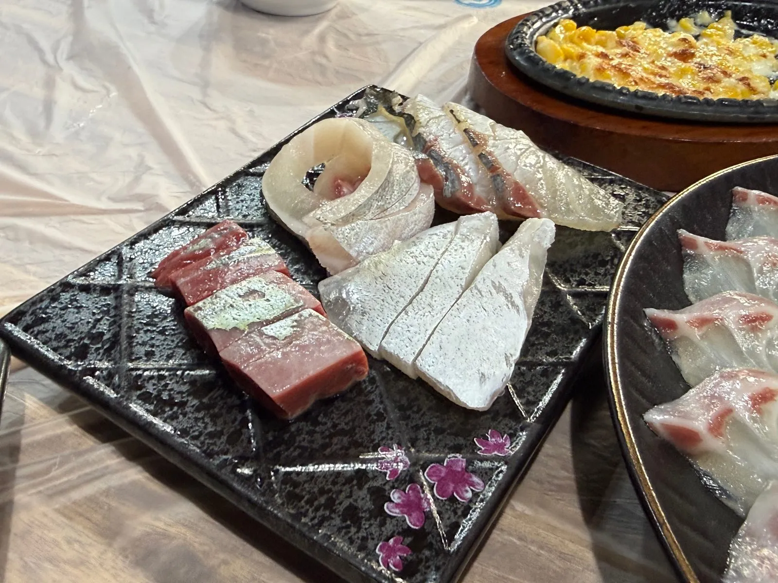 A few special cuts of fish on a square patterned plate