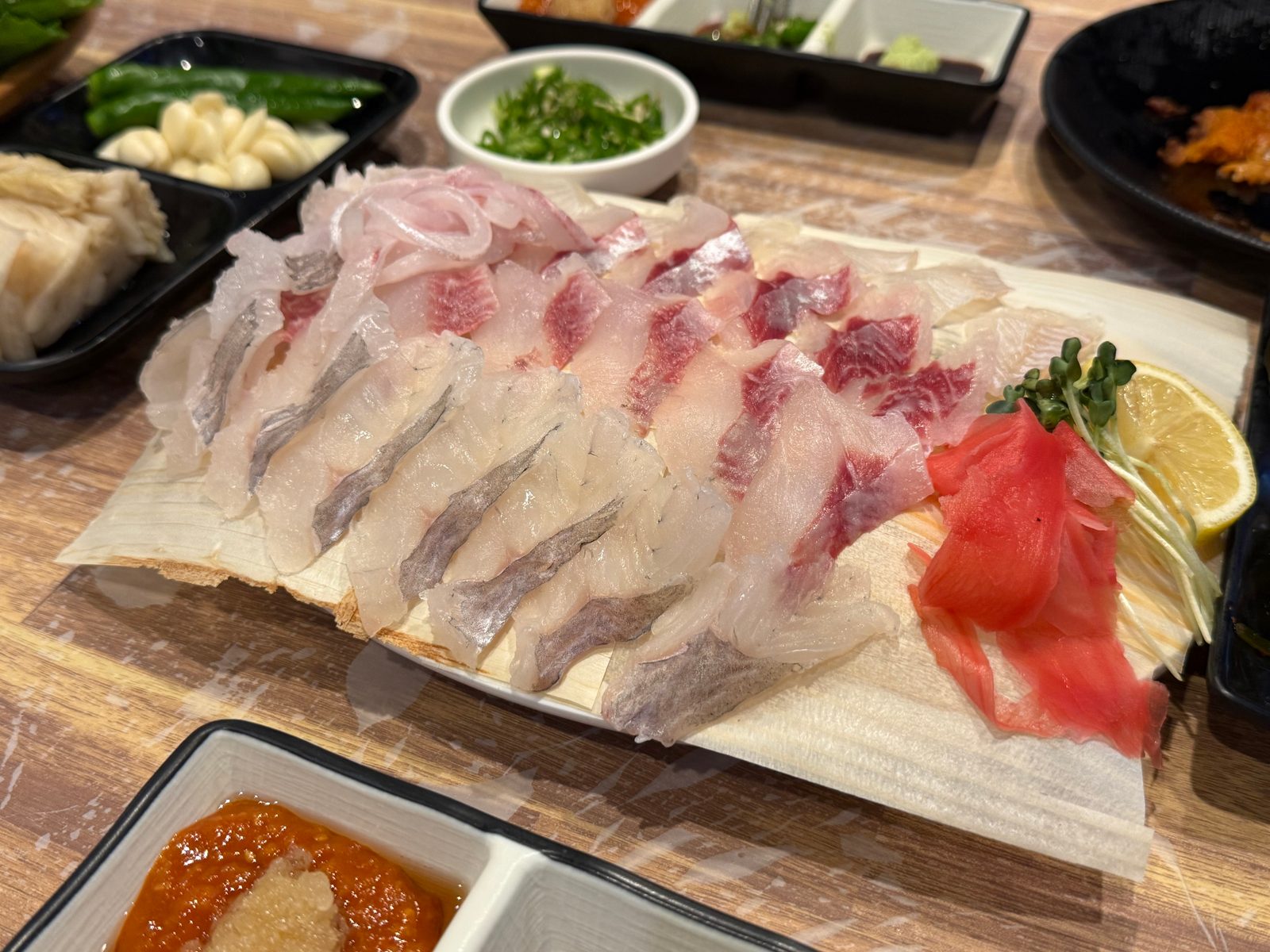 An assorted sashimi platter spread across a large plate